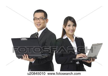 Businessman and a businesswoman working on laptops View Large Photo Image Stock Image - Businessman and a businesswoman working on laptops. Fotosearch