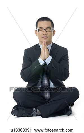 Stock Image - Businessman meditating. Fotosearch