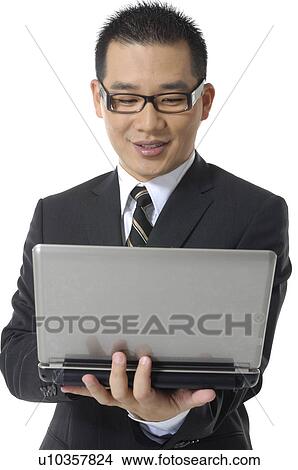 Businessman working on a laptop View Large Photo Image Picture - Businessman working on a laptop. Fotosearch