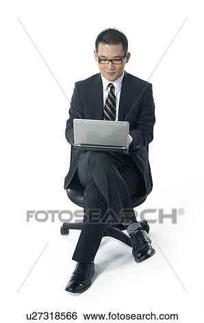 Stock Photograph - Businessman working on a laptop. Fotosearch