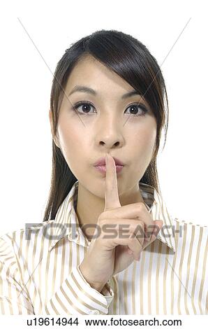 Picture - Businesswoman with finger on her lips. Fotosearch