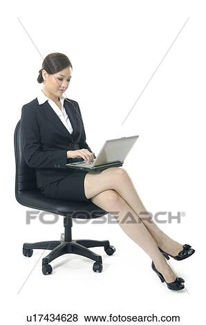 Businesswoman working on a laptop View Large Photo Image Stock Photo - Businesswoman working on a laptop. Fotosearch