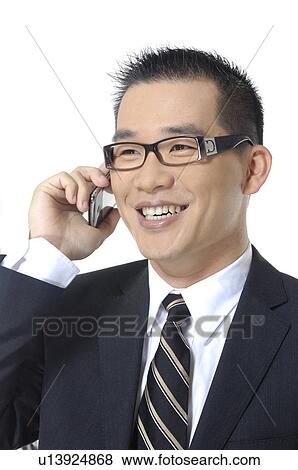Stock Photo - Close-up of a businessman talking on a mobile phone. Fotosearch