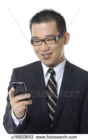 Close-up of a businessman text messaging View Large Photo Image Stock Image - Close-up of a businessman text messaging. Fotosearch