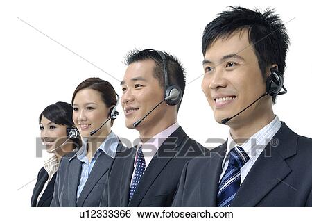 Stock Photograph - Four customer care executives smiling. Fotosearch