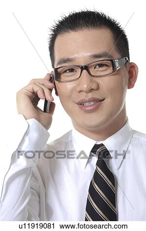 Stock Image - Portrait of a businessman talking on a mobile phone. Fotosearch