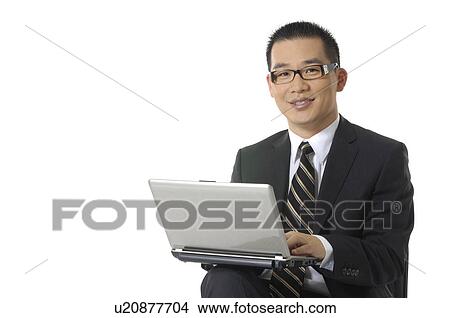 Picture - Portrait of a businessman working on a laptop. Fotosearch