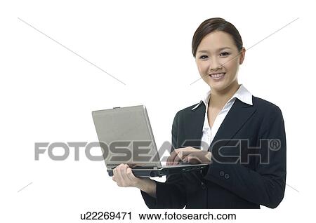 Portrait of a businesswoman working on a laptop View Large Photo Image Stock Image - Portrait of a businesswoman working on a laptop. Fotosearch