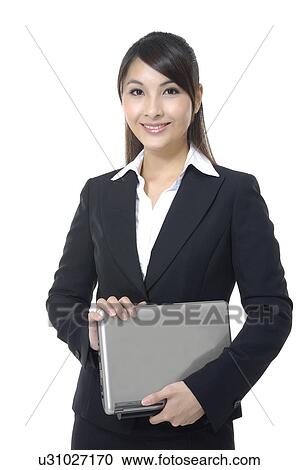 Stock Image - Portrait of a businesswoman working on a laptop. Fotosearch