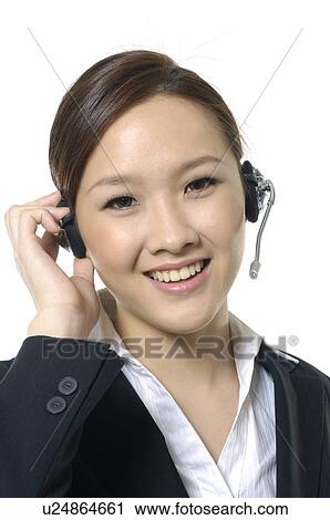 Portrait of a female customer care executive smiling View Large Photo Image Stock Image - Portrait of a female customer care executive smiling. Fotosearch