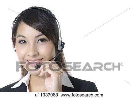 Stock Photo - Portrait of a female customer care executive smiling. Fotosearch