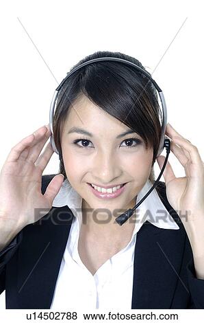 Stock Photo - Portrait of a female customer care executive smiling. Fotosearch