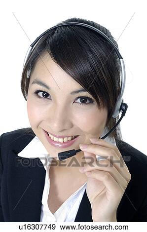 Stock Photo - Portrait of a female customer care executive smiling. Fotosearch