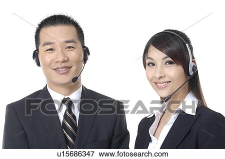 Portrait of a male and a female customer care executives smiling View Large Photo Image Stock Photo - Portrait of a male and a female customer care executives smiling. Fotosearch