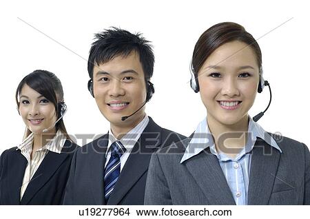 Picture - Portrait of three customer care executives smiling. Fotosearch