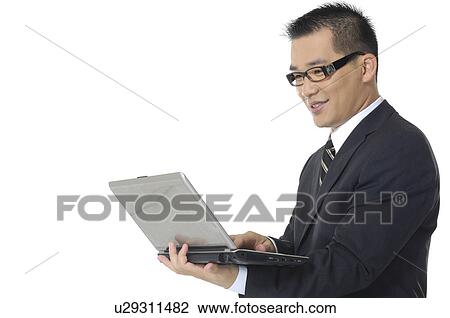 Side profile of a businessman working on a laptop View Large Photo Image Stock Image - Side profile of a businessman working on a laptop. Fotosearch