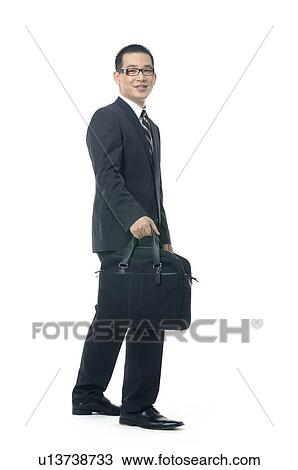Stock Image - Businessman carrying a hand bag. Fotosearch