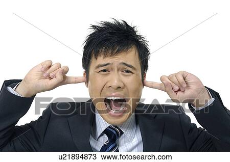 Stock Image - Businessman covering his ears and shouting. Fotosearch