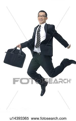 Stock Photography - Businessman holding a bag and jumping. Fotosearch
