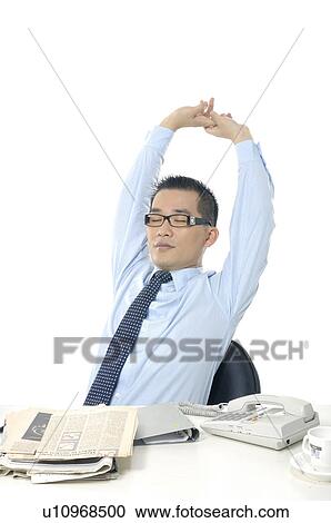 Stock Image - Businessman relaxing on a chair. Fotosearch
