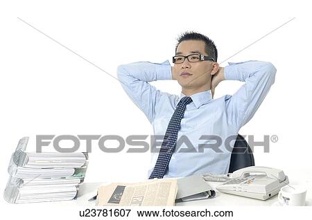 Businessman relaxing on a chair View Large Photo Image Stock Photo - Businessman relaxing on a chair. Fotosearch