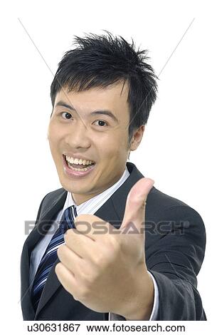 Stock Photo - Businessman showing thumbs up and smiling. Fotosearch