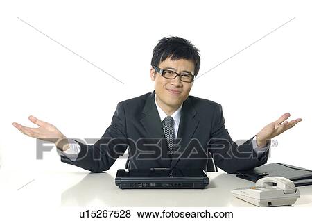 Businessman shrugging in confusion View Large Photo Image Stock Photo - Businessman shrugging in confusion. Fotosearch