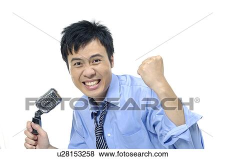 Businessman singing into a microphone View Large Photo Image Stock Photo - Businessman singing into a microphone. Fotosearch