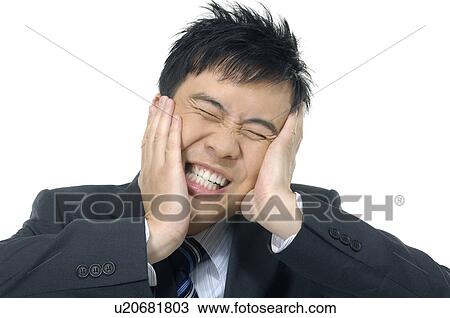 Businessman Suppressing his face and clenching his teeth View Large Photo Image Stock Image - Businessman Suppressing his face and clenching his teeth. Fotosearch