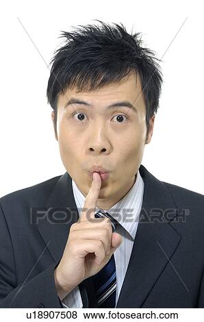 Stock Photo - Businessman with finger on his lips. Fotosearch