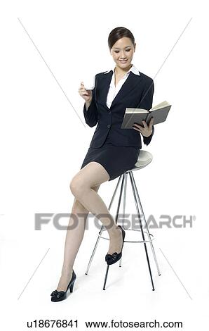 Businesswoman holding a file and rubbing her temple View Large Photo Image Stock Image - Businesswoman holding a file and rubbing her temple. Fotosearch
