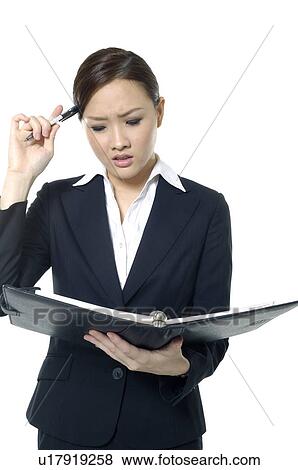Stock Photo - Businesswoman holding a planner and drinking tea. Fotosearch