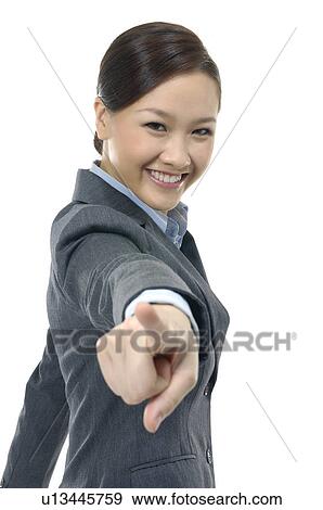 Stock Photo - Businesswoman pointing forward and smiling. Fotosearch