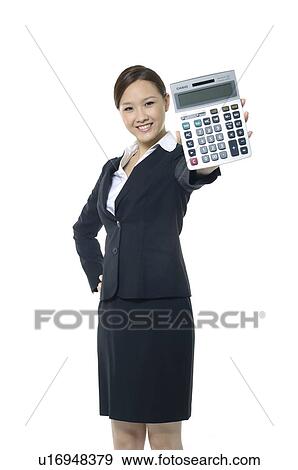 Stock Photo - Businesswoman showing a calculator. Fotosearch