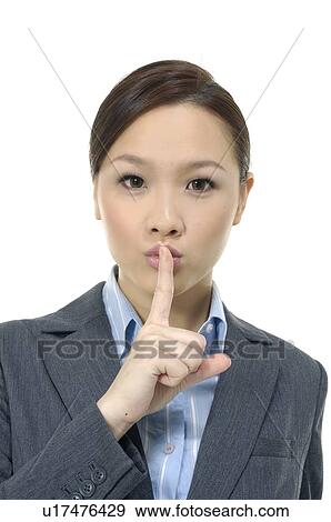 Stock Photo - Businesswoman with finger on his lips. Fotosearch