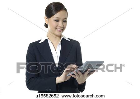 Businesswoman working on a calculator View Large Photo Image Stock Image - Businesswoman working on a calculator. Fotosearch