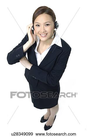 Stock Photo - Portrait of a female customer care executive smiling. Fotosearch