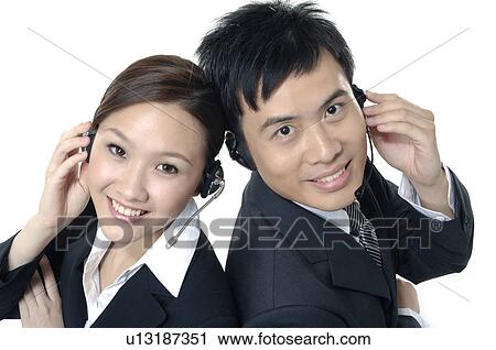 Portrait of a male and a female customer care executives smiling View Large Photo Image Stock Image - Portrait of a male and a female customer care executives smiling. Fotosearch