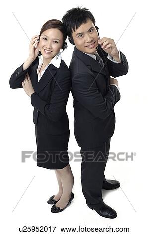 Stock Photo - Portrait of a male and a female customer care executives smiling. Fotosearch