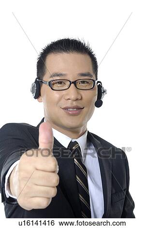Portrait of a male customer care executive showing thumbs up View Large Photo Image Stock Photograph - Portrait of a male customer care executive showing thumbs up. Fotosearch