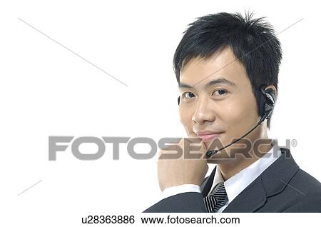 Portrait of a male customer care executive smiling View Large Photo Image Stock Photograph - Portrait of a male customer care executive smiling. Fotosearch