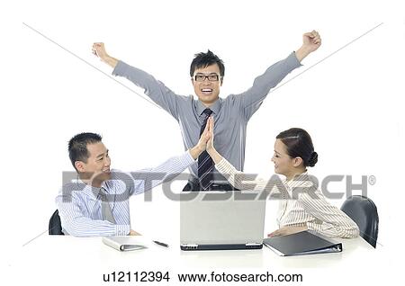 Two businessmen and a businesswoman celebrating their success View Large Photo Image Picture - Two businessmen and a businesswoman celebrating their success. Fotosearch