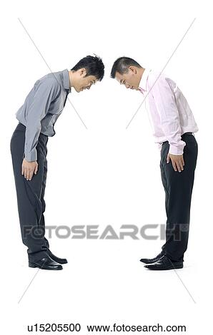 Two businessmen paying regards to each other View Large Photo Image Stock Image - Two businessmen paying regards to each other. Fotosearch