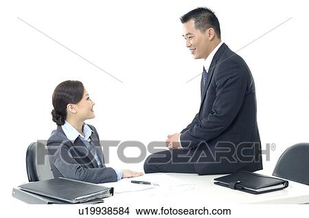 Businessman and a businesswoman looking at each other View Large Photo Image Picture - Businessman and a businesswoman looking at each other. Fotosearch