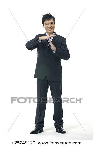 Stock Image - Businessman showing time out signal. Fotosearch