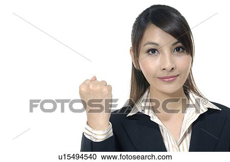 Stock Image - Businesswoman clenching her fist. Fotosearch
