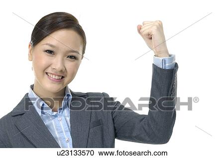 Businesswoman clenching her fist View Large Photo Image Stock Image - Businesswoman clenching her fist. Fotosearch