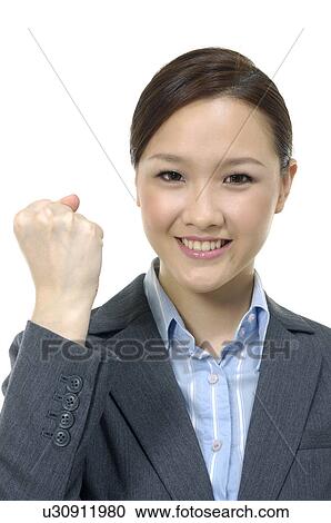 Stock Image - Businesswoman clenching her fist. Fotosearch
