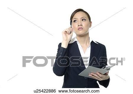 Stock Photograph - Businesswoman holding a file and rubbing her temple. Fotosearch