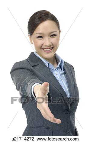 Stock Image - Businesswoman offering for handshake. Fotosearch